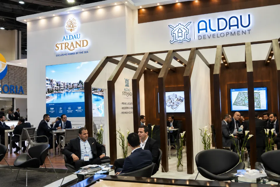 Al Dau Development booth with warm wood-grain design